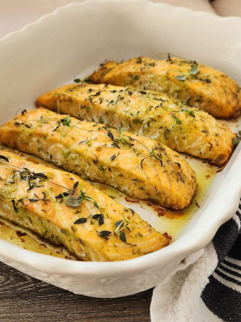 Fillets of baked salmon with basil and thyme in baking dish