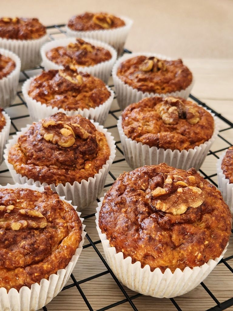 High-protein banana cottage cheese muffins stacked on cooling rack