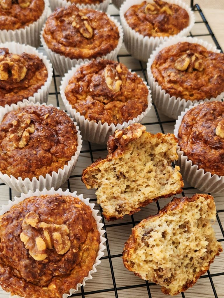 High-protein banana cottage cheese muffin broken in half showing soft and moist interior on cooling rack