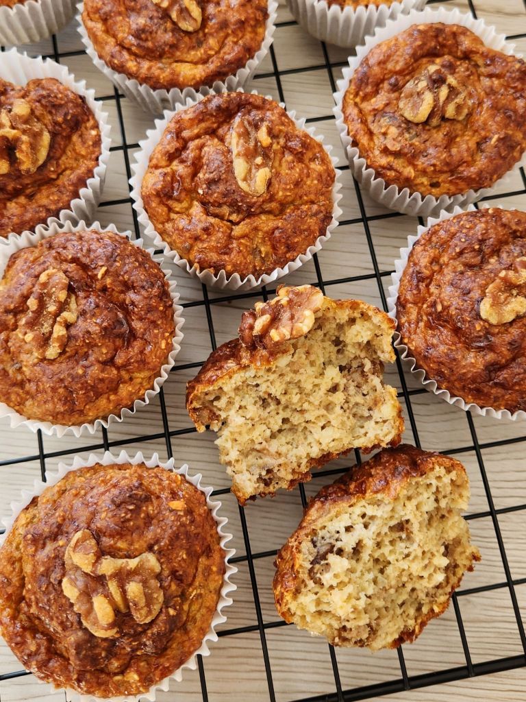 High-protein banana cottage cheese muffin broken in half showing soft and moist interior on cooling rack