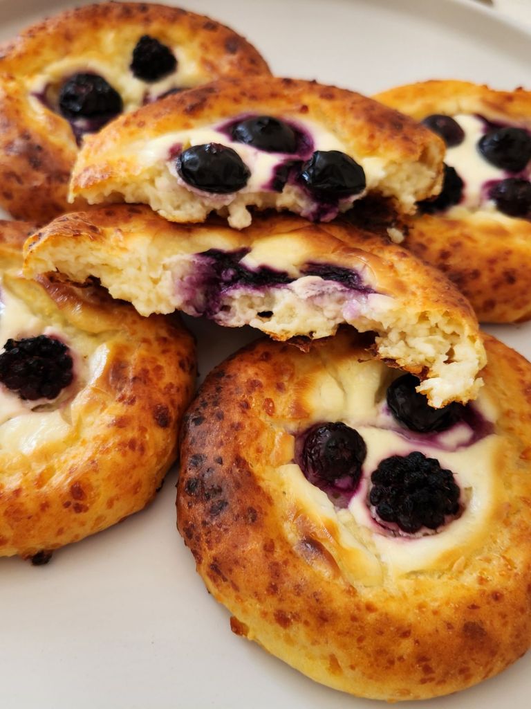 Cottage cheese brioche bun broken in half revealing soft, airy interior