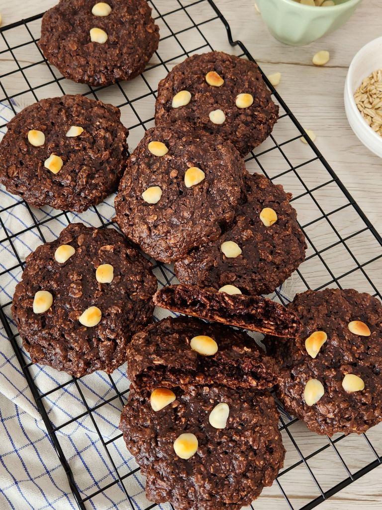 High-protein chocolate oat cookies stacked on rack