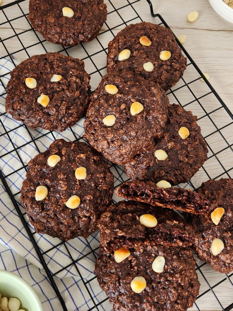 High-protein chocolate oat cookies stacked on rack
