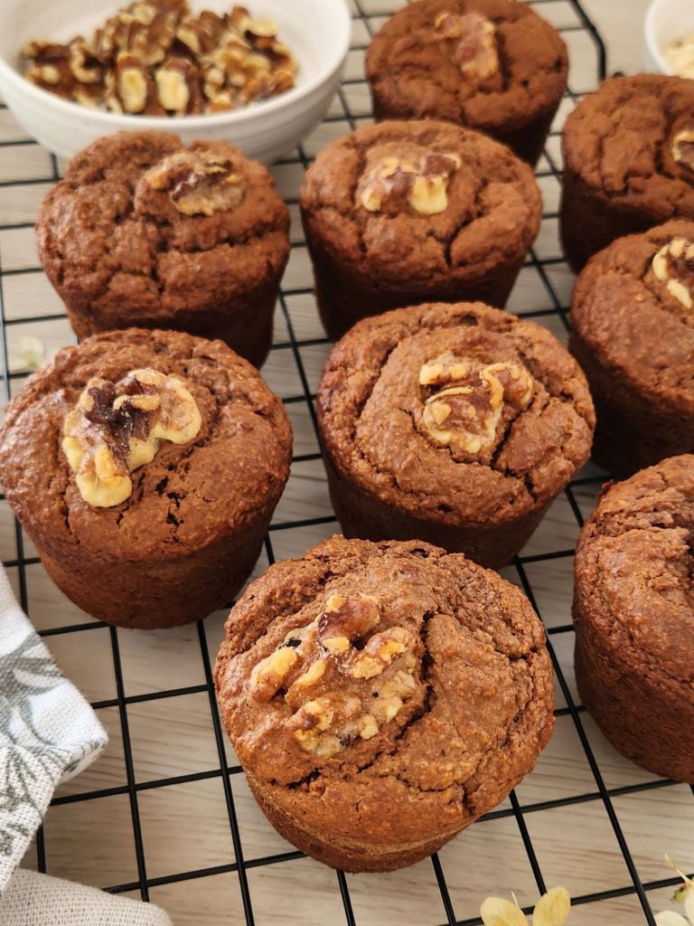 High-protein oat peanut butter cocoa muffins with apple purée and honey on a cooling rack