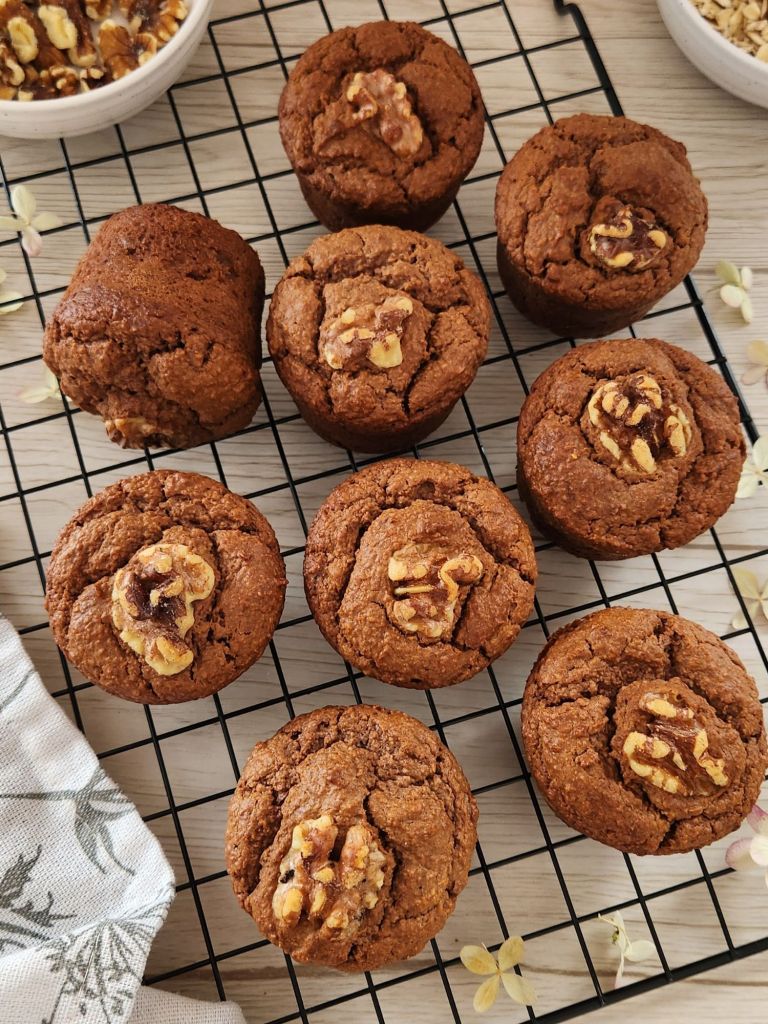 High-protein oat peanut butter cocoa muffins with apple purée and honey on a cooling rack