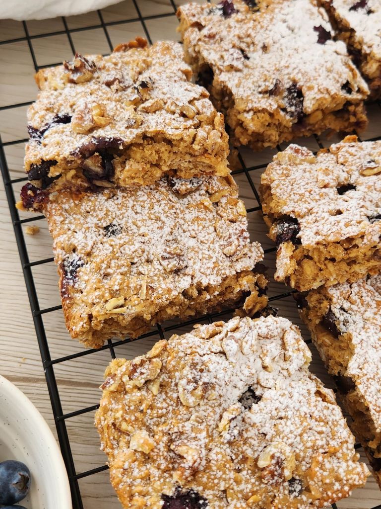 Close-up of Blueberry peanut butter oat bars made with rolled oats and maple syrup on a cooling rack