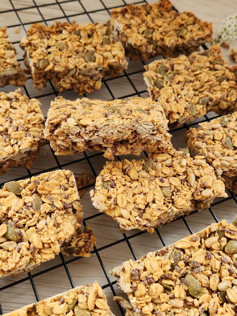 Crunchy oat bars with sunflower seeds, pumpkin seeds, flaxseed on a baking rack