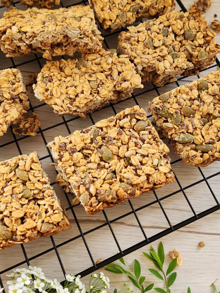 Crunchy oat bars with sunflower seeds, pumpkin seeds, flaxseed on a baking rack