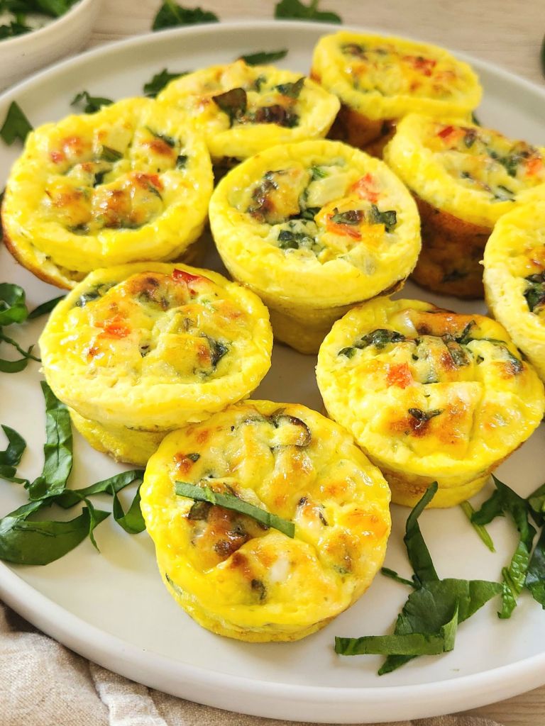 Healthy spinach feta Egg Muffins on a white plate 