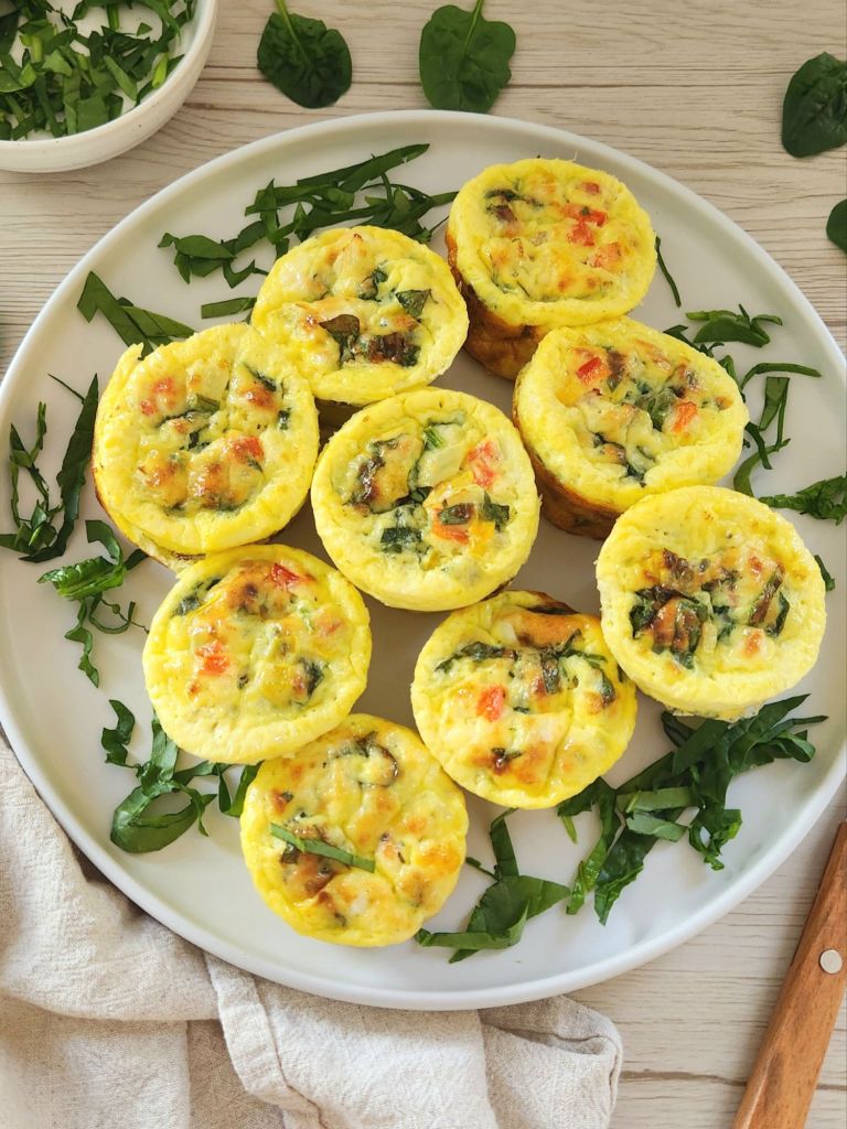 Healthy spinach feta Egg Muffins on a white plate 